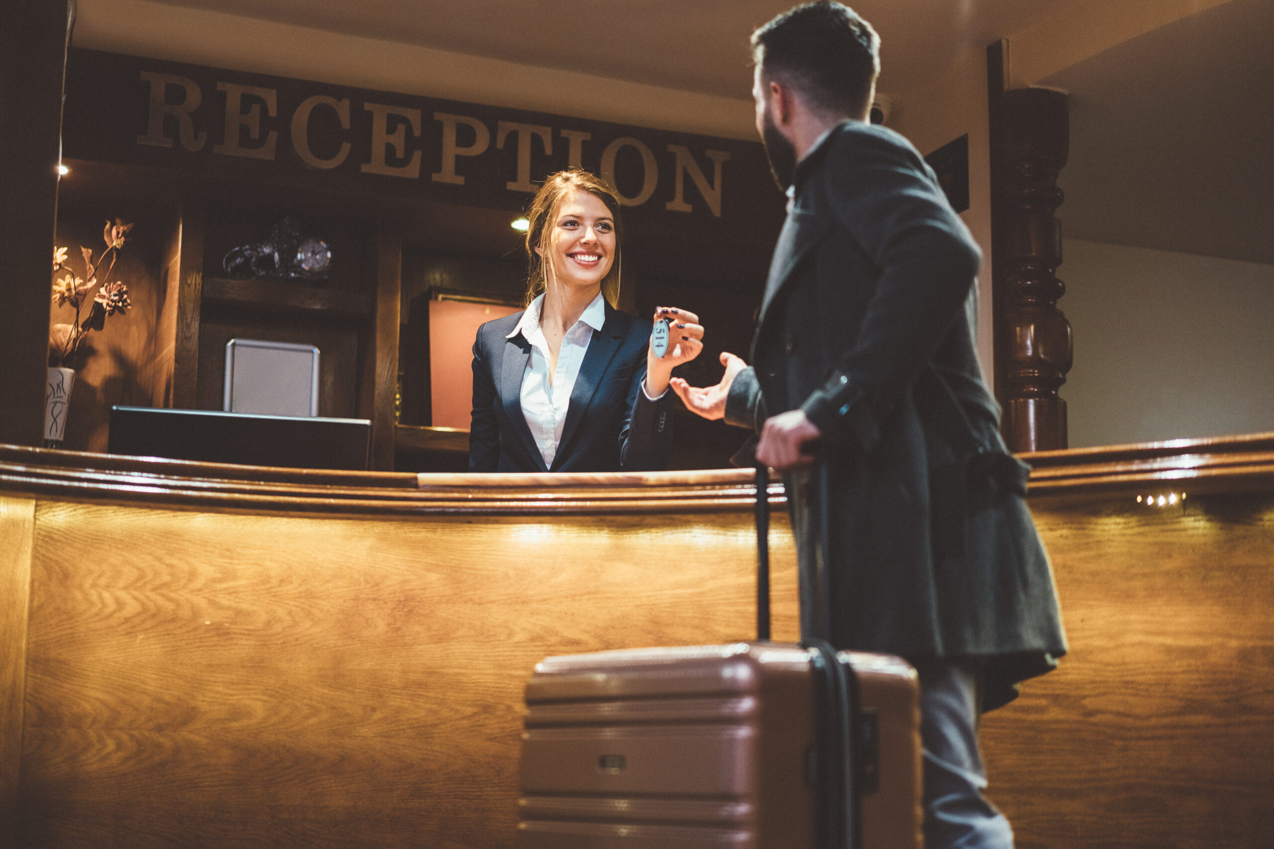Receptionist giving keys to hotel guest